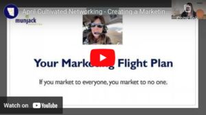 Image of Cover Page of presentation. Features speaker in an airplane with the text, "creating a marketing flight path"